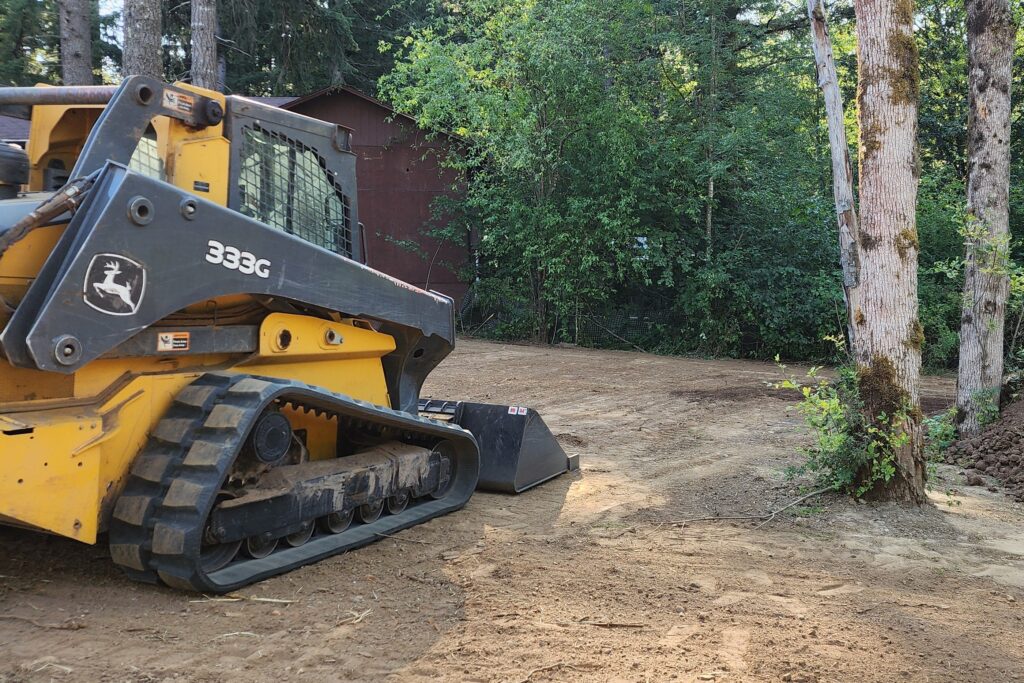 A bulldozer stands on cleared land