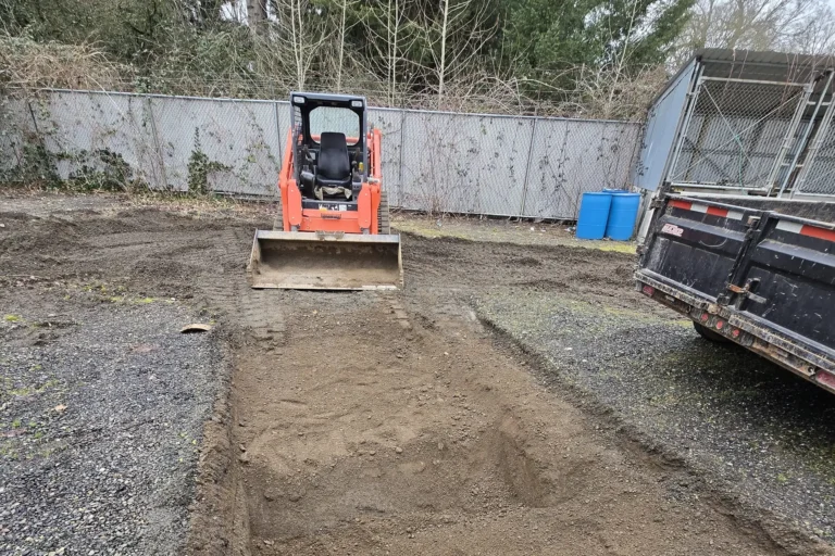 A bulldozer digs a hole for leveling.